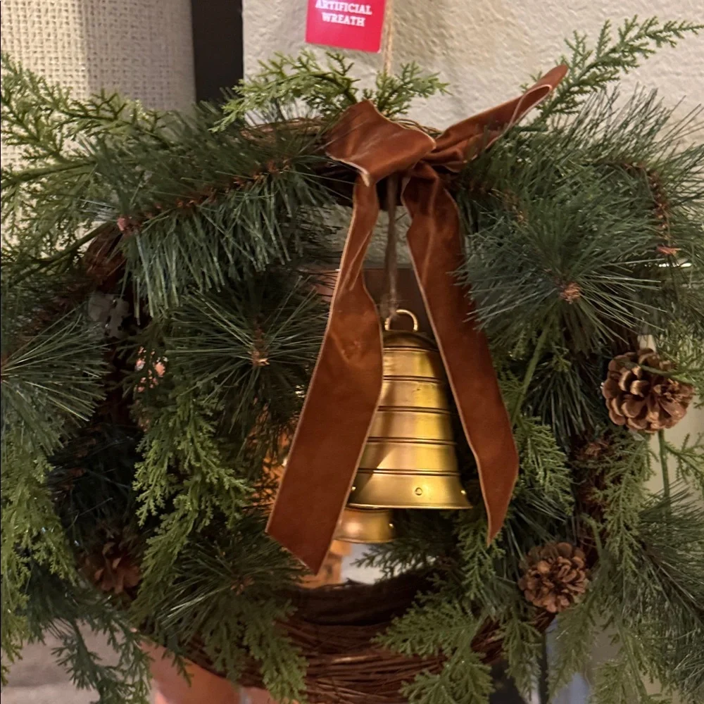 Elegant Holiday Wreath with Gold Bell and Brown Ribbon